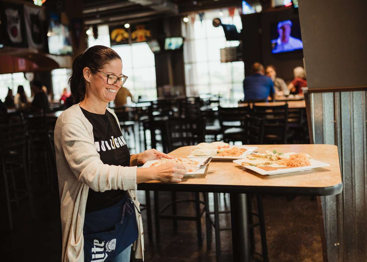 Waitress serving entrees