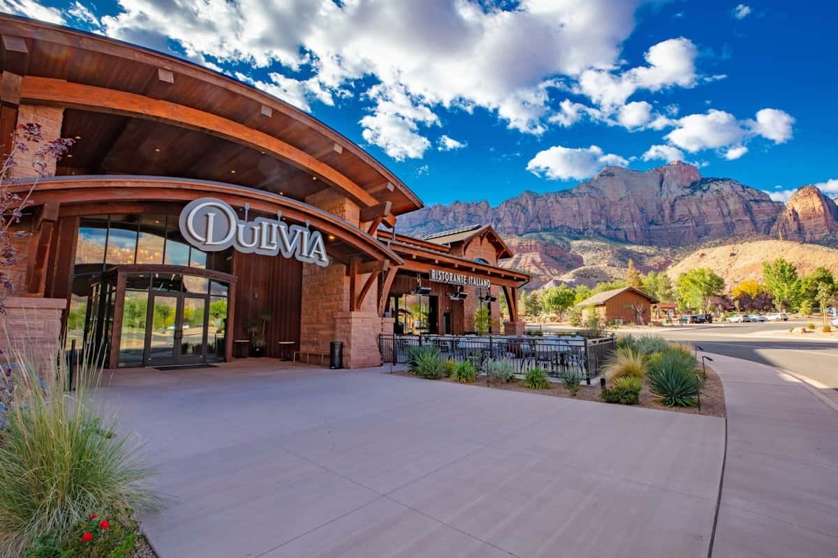 Exterior of Dulivia Ristorante Italiano in Springdale, Utah, with elegant entrance, mountain views near Zion National Park, and an inviting upscale Italian dining atmosphere.