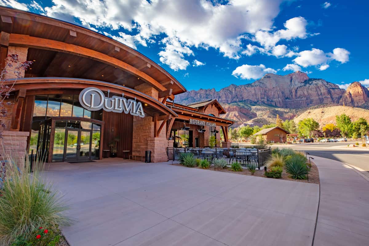 Exterior of Dulivia Ristorante Italiano in Springdale, Utah, with elegant entrance, mountain views near Zion National Park, and an inviting upscale Italian dining atmosphere.