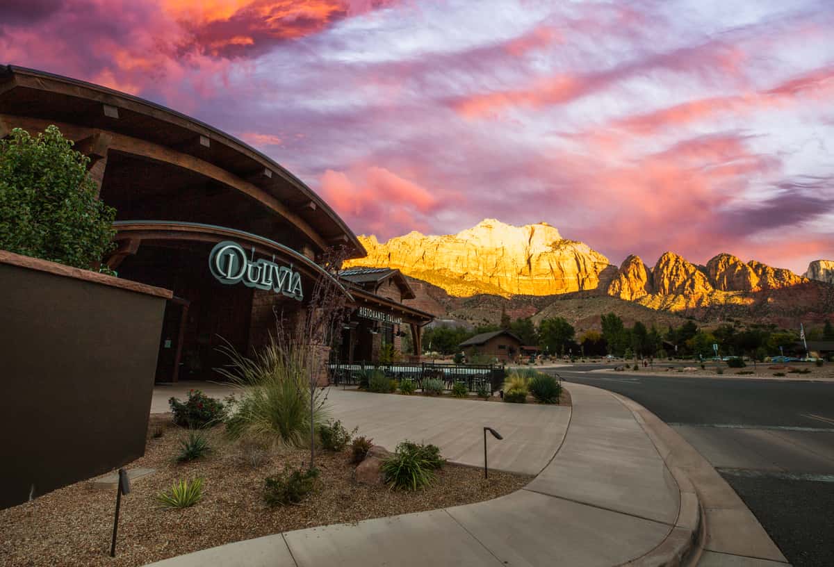 Dulivia Ristorante Italiano at sunset in Springdale, Utah, with glowing red rock mountain views and an elegant exterior near Zion National Park.