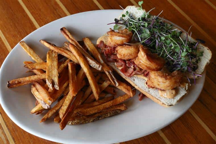 Po-Boy sandwich with a side of fries.