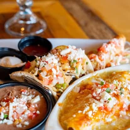 Plates of seafood and Mexican-style dishes served together