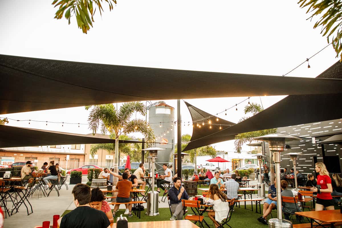 Photo of beer garden full of people.