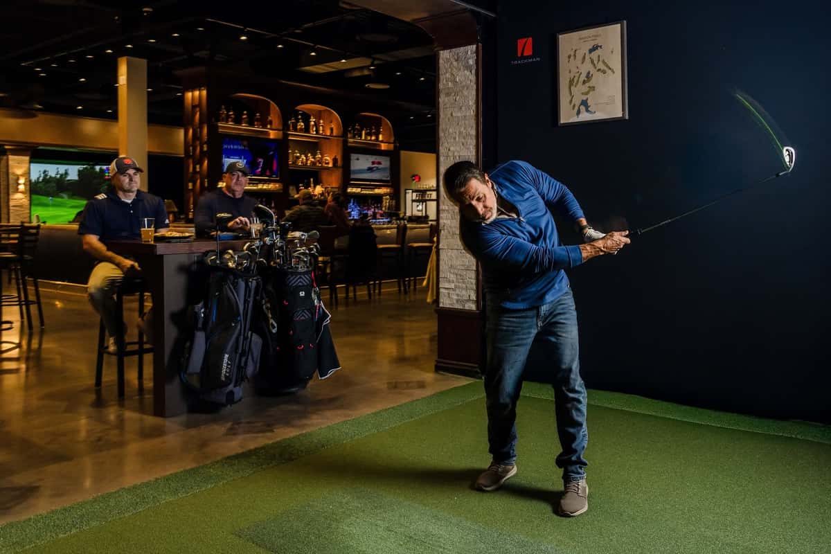 Man Swinging a Golf Car