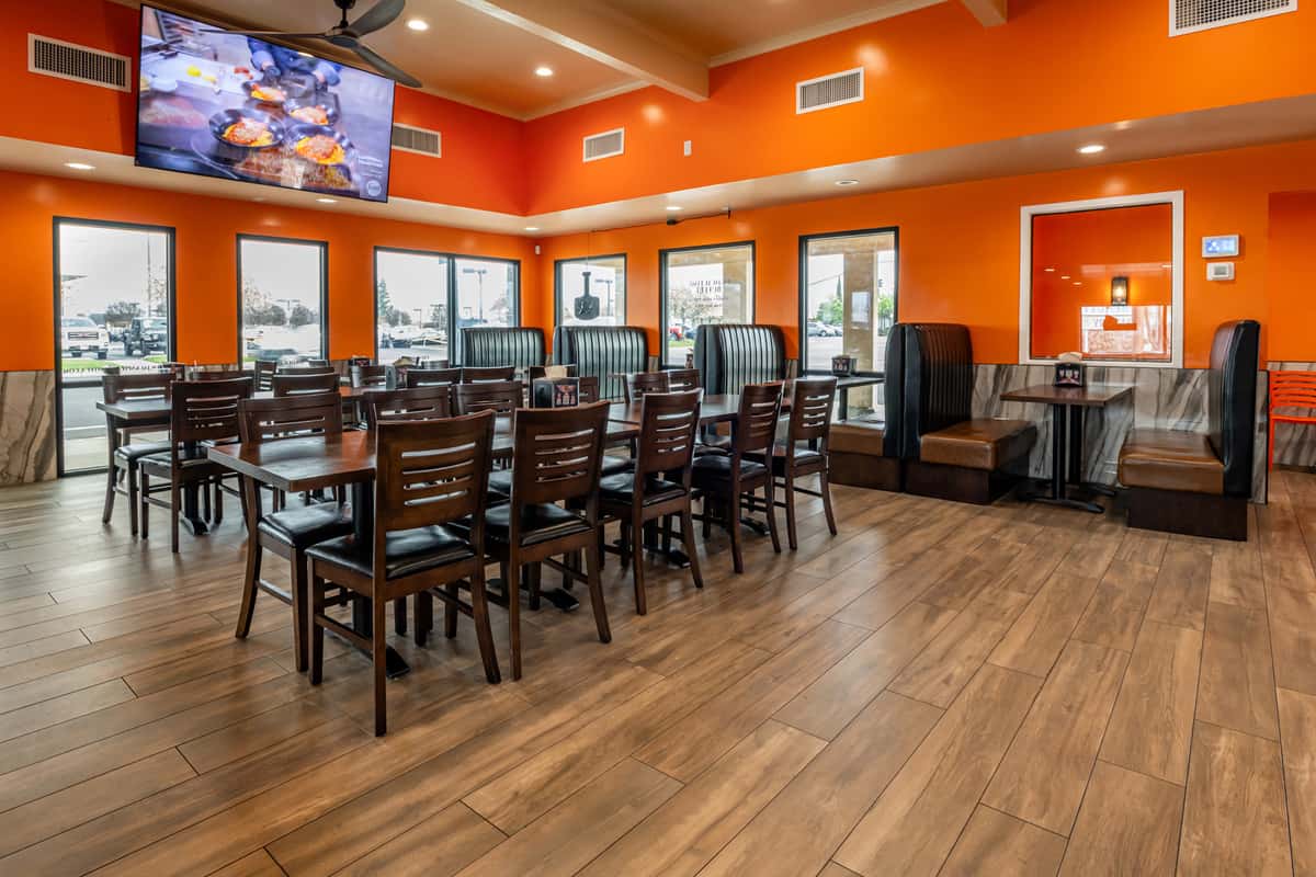 Interior dining room with tables, chairs and a tv
