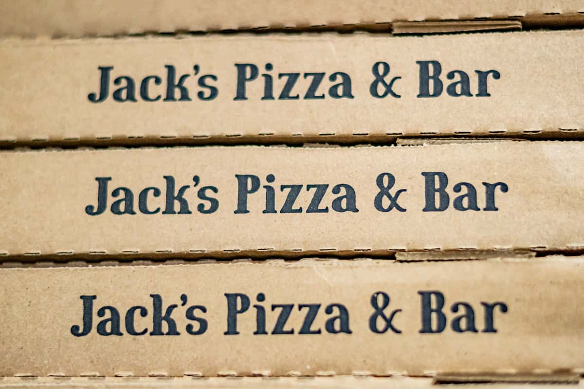 A stack of Jack's Pizza & Bar branded pizza boxes