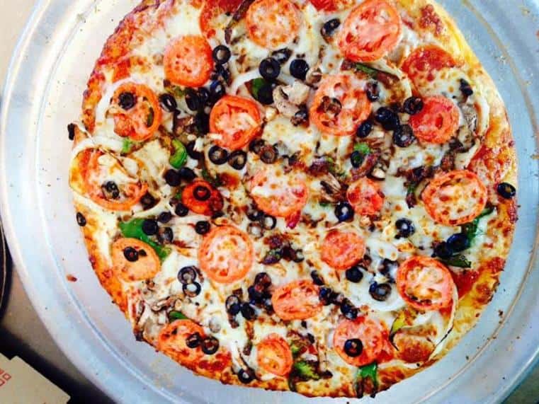 pizza with tomatoes and black olives