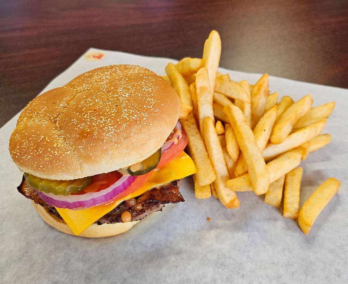 Came on Kaiser Bun with Bacon, Secret Sauce, Pickles, Red Onions, Tomatoes, and American Cheese, served with fries