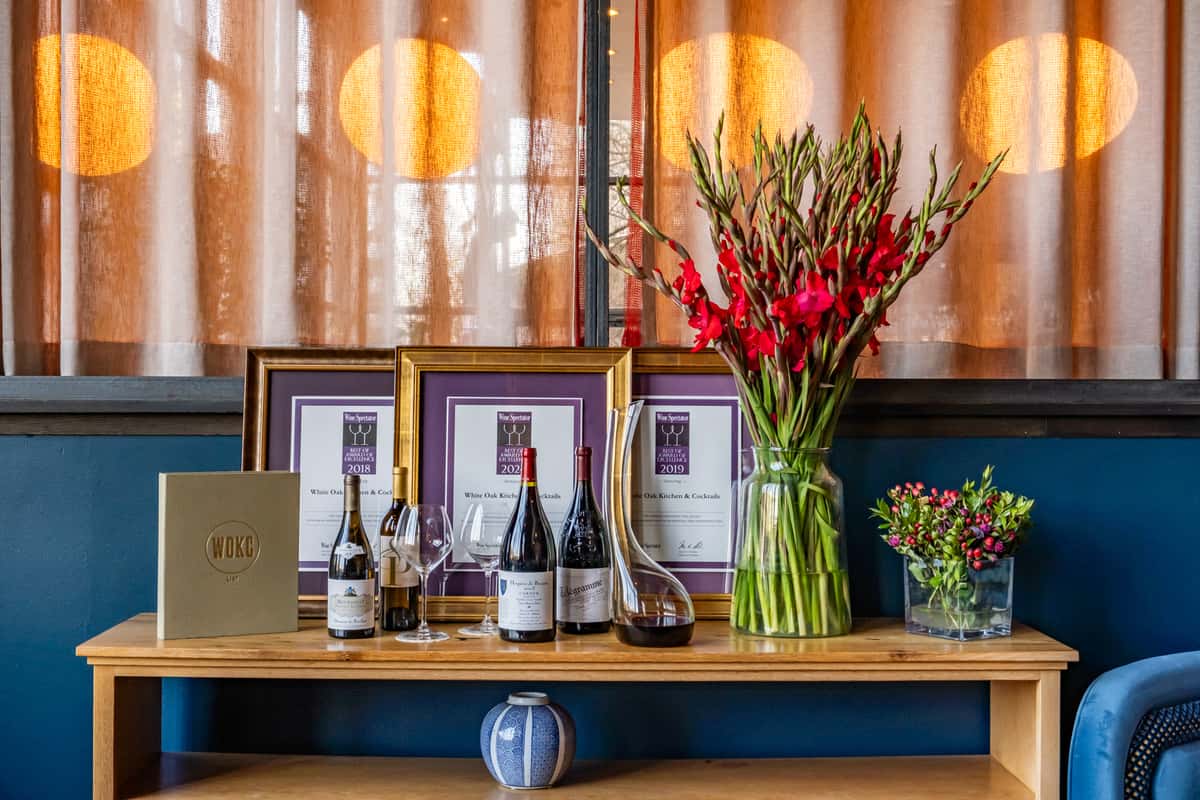 Wine bottles, glasses and flowers