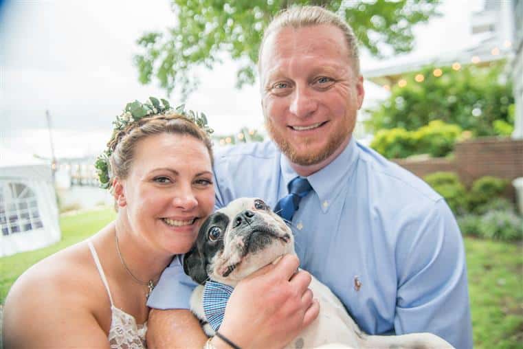 Regan, the Innkeeper, with her husband, Casey, and their Boston Terrier, Murphy.