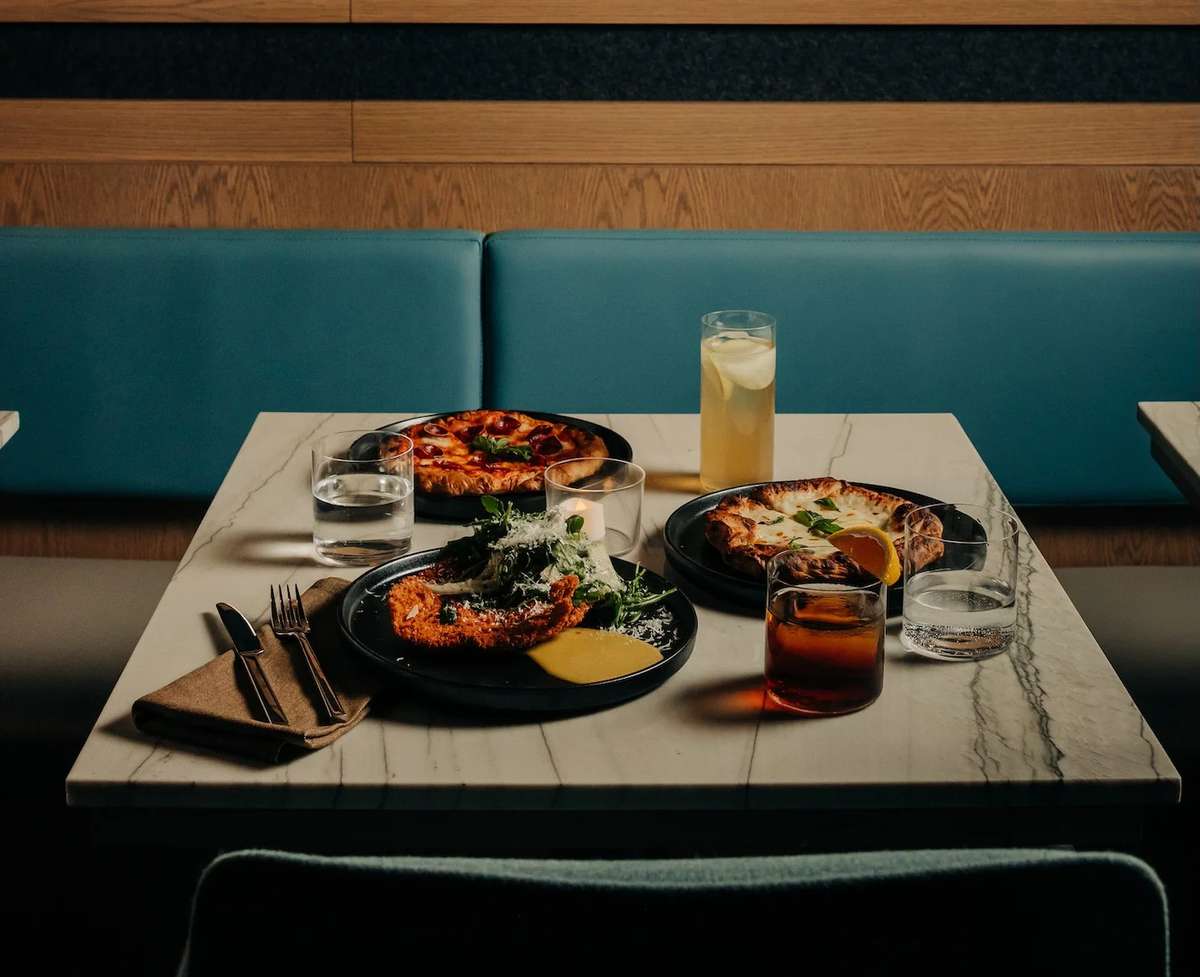 Table with food dishes and cocktails