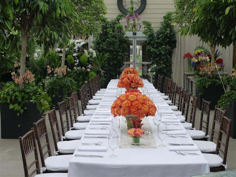 long decorated table with flowers in the middle