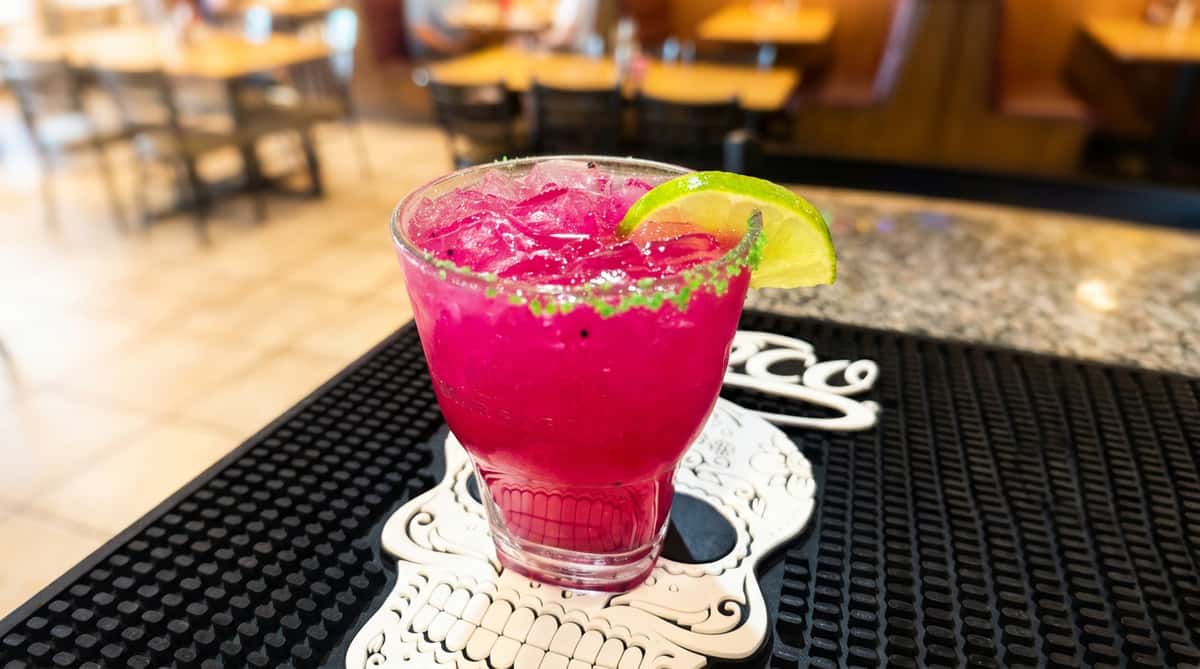 Bright pink dragon fruit margarita with a lime garnish served at Maya Mexican Restaurant, a lively Tex-Mex restaurant in Homewood and Alabaster, Alabama.