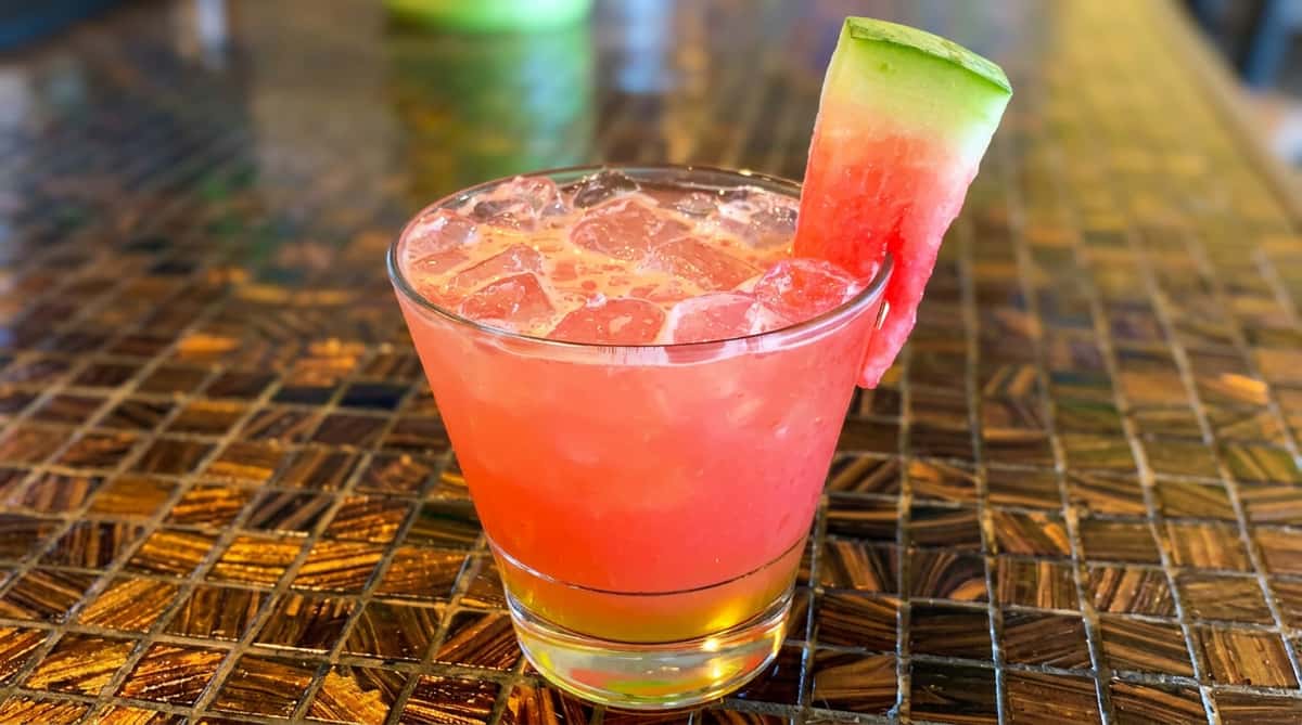Refreshing watermelon cocktail with a lime garnish served at Maya Mexican Restaurant in Homewood and Alabaster, Alabama.