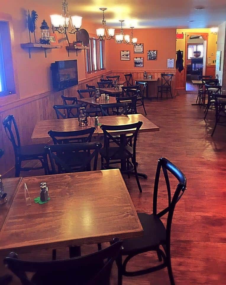 Interior dining area. Wood tables with lanterns.