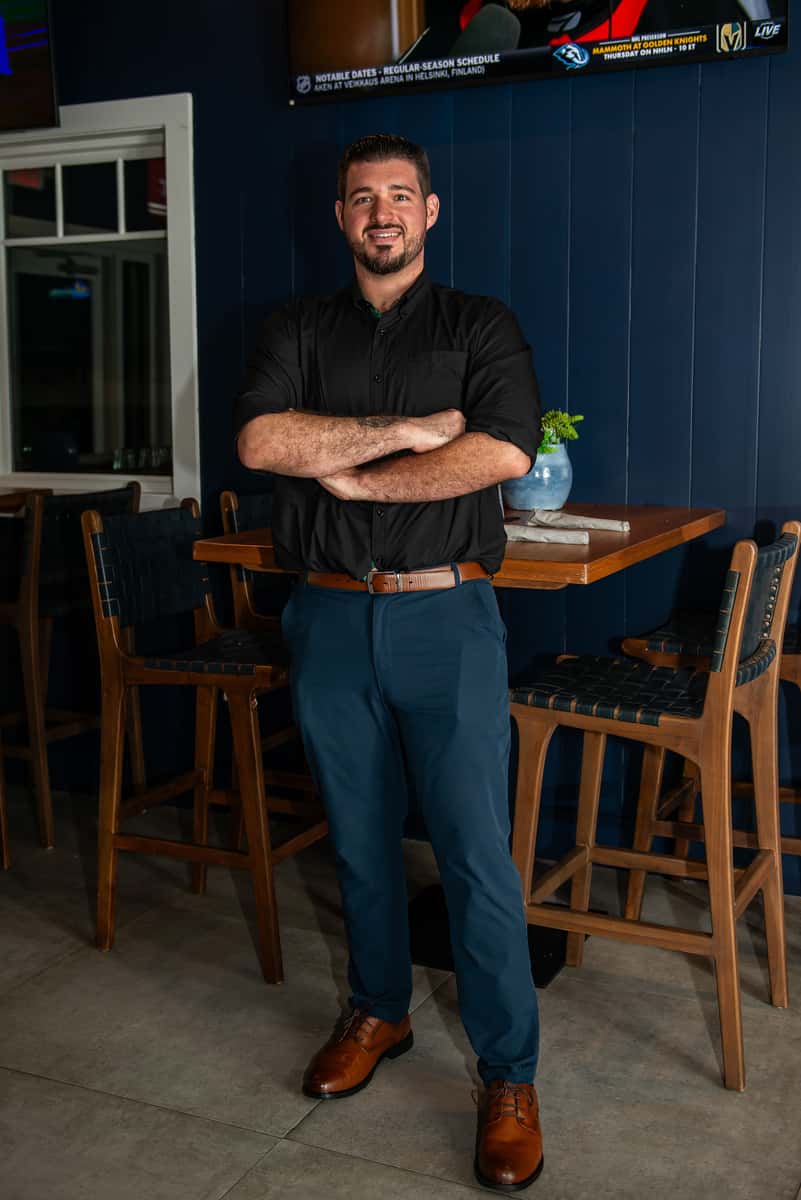 Haven Bartlett, General Manager of Fin & Tonic in Sarasota, smiling in a full-body portrait from the September 2026 professional photo shoot