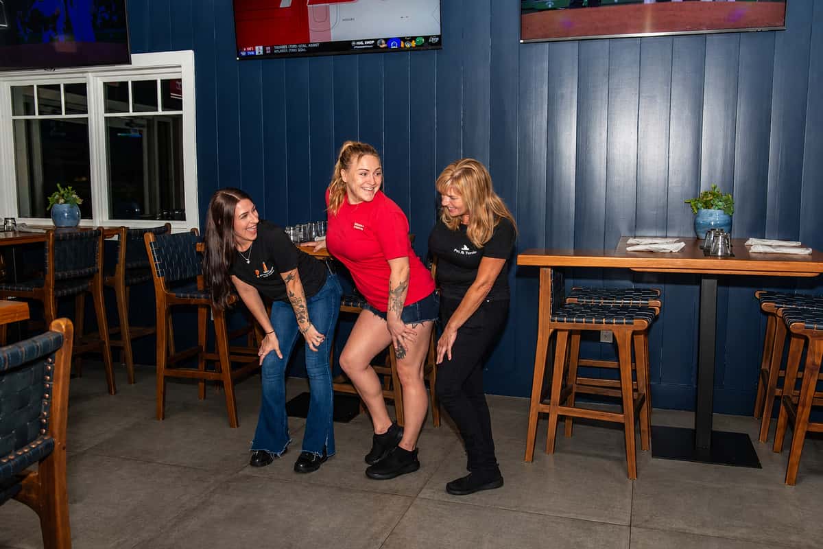 Fin & Tonic hospitality team in the Sarasota restaurant — approved edited September 2026 professional photo