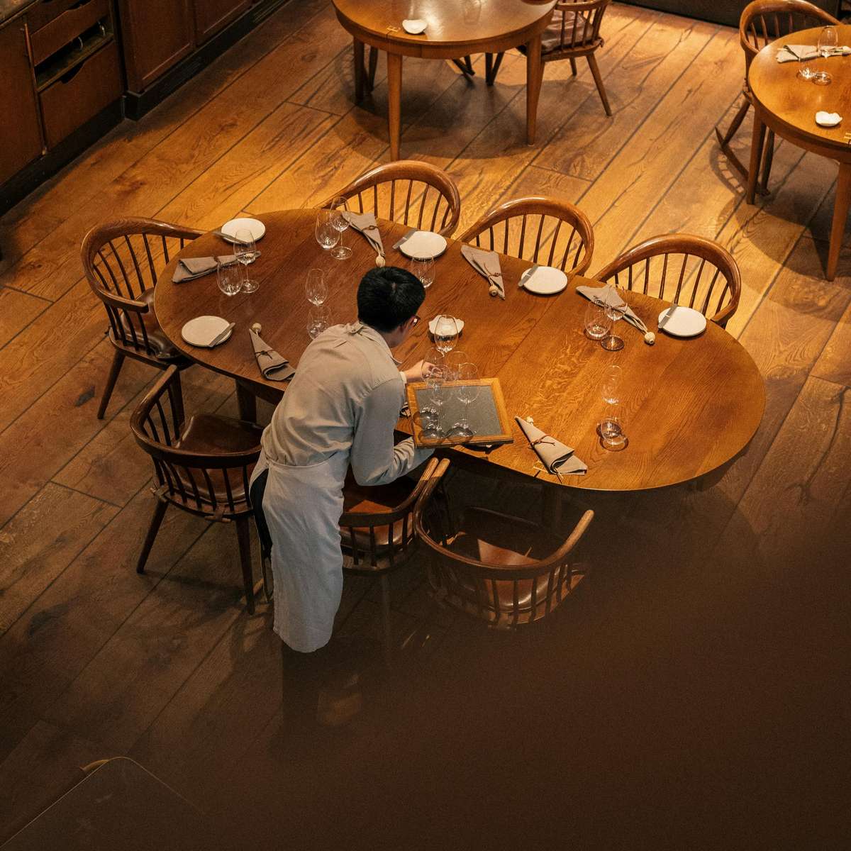 Waiter tending to tables