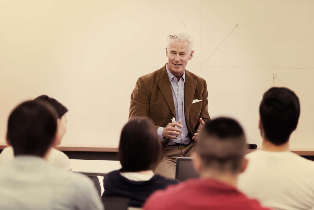 a man speaking in front of a crowd
