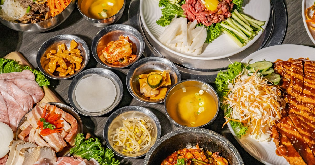 Korean barbecue catering spread with meats and banchan