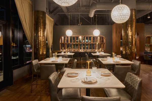 Gold Room at Fitoor Santa Monica featuring intimate round-table dining and gold drapery for private events and celebrations