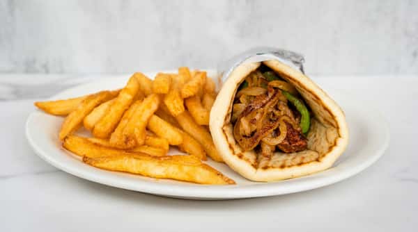 Philly cheesesteak pita stuffed with seasoned beef, melted cheese, and sautéed vegetables, served with golden crinkle-cut fries.