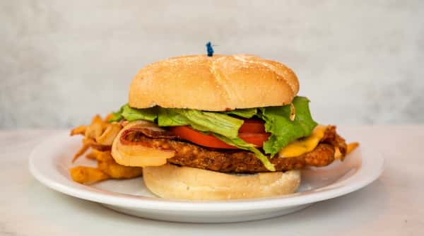 Selection of freshly prepared breakfast, lunch, and comfort food dishes, including omelets, sandwiches, fried chicken, and homemade desserts.