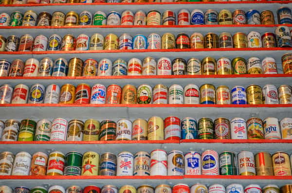 Closeup on an entire wall full of different beer cans.