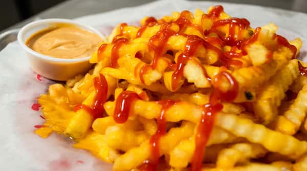 Cheese fries drizzled with ketchup