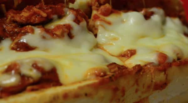 Closeup of a chicken parmesan hero.