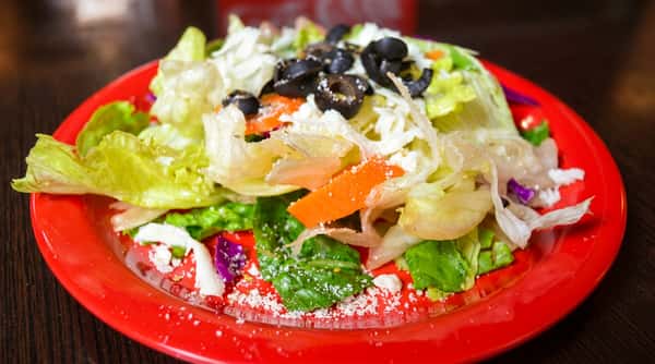 Fresh garden salad with black olives and carrots