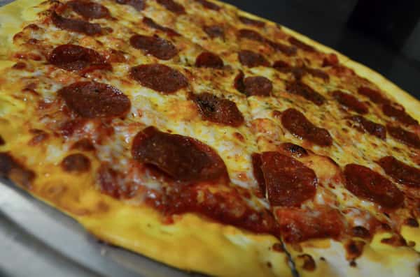 Closeup of a whole pepperoni pizza pie.
