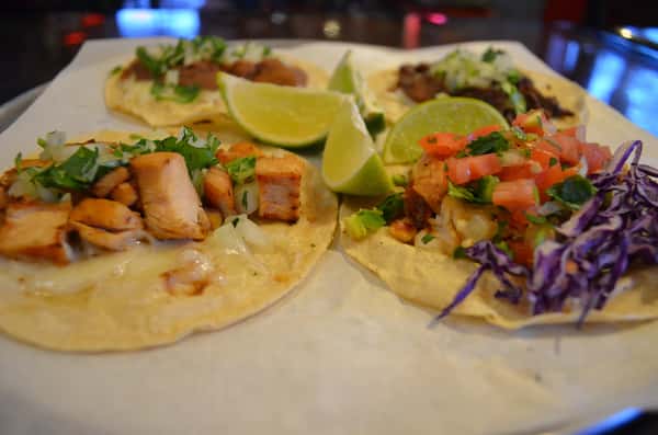 Plate of four different tacos.