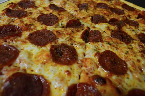 Closeup of a whole pepperoni pizza pie.
