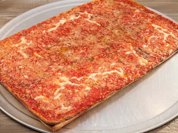 large flat pizza with sauce