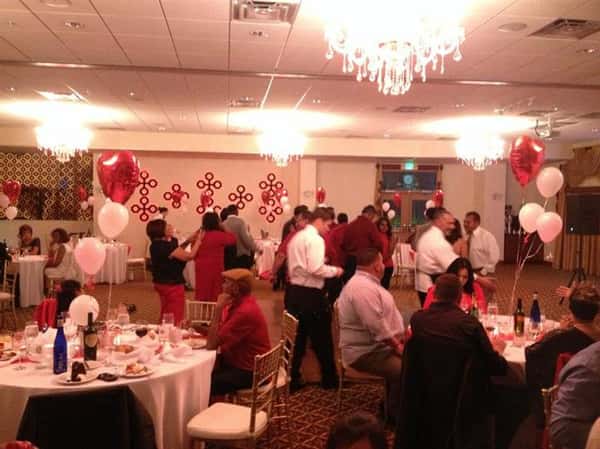 banquet room filled with people for valentine's day dinner event