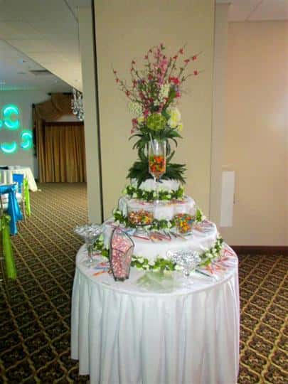 large birthday cake on top of a clothed-table