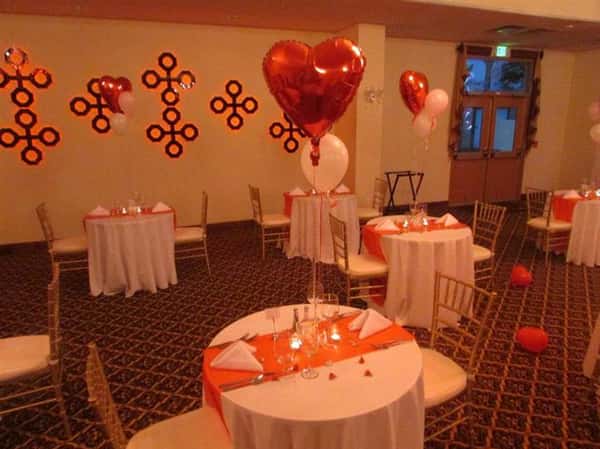 several round tables decorated with balloons