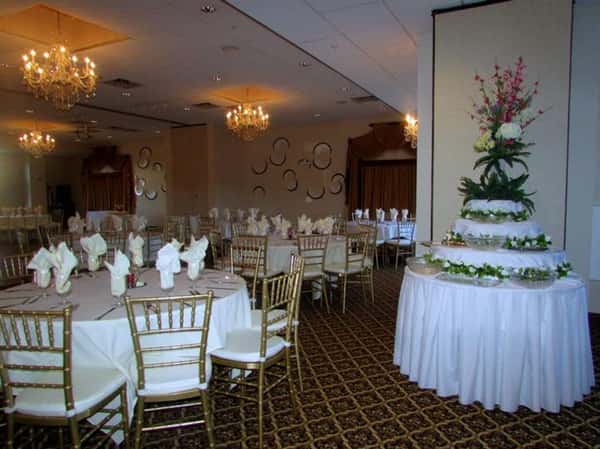 banquet room with several tables decorated for sita's 60th birthday party