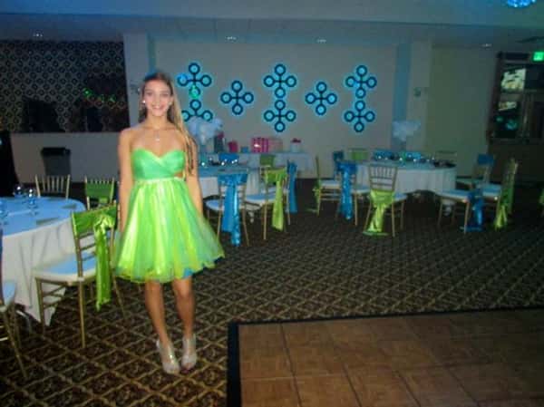 carlyn posing for picture in front of decorated round tables