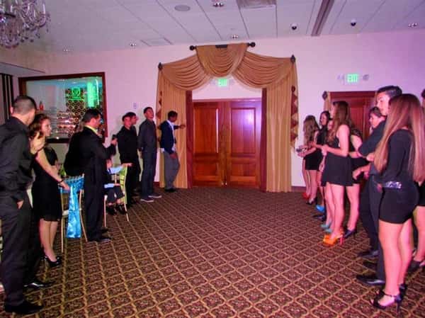 group of people waiting to surprise someone when they come through double doors