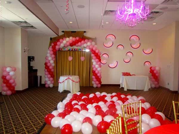 balloons covering dance floor and hung above wooden door