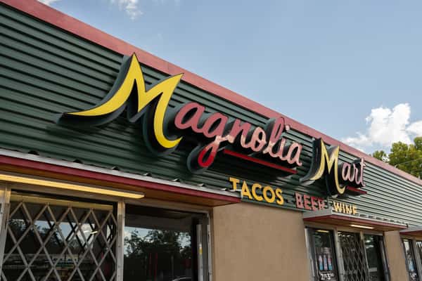 Medium exterior view of the Magnolia Mart sign and storefront.