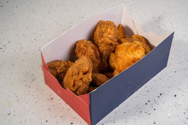 Fried chicken and biscuits served in a red and blue takeout box.