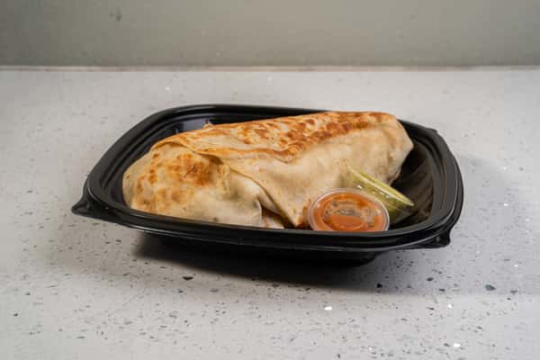 Eagle Nest burrito served in a black takeout tray with dipping sauce.