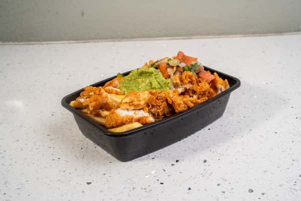 Loaded fries topped with meat, cheese, vegetables, and guacamole in a black tray.