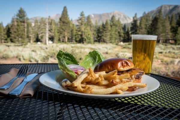 Burger on a table with a mountain view