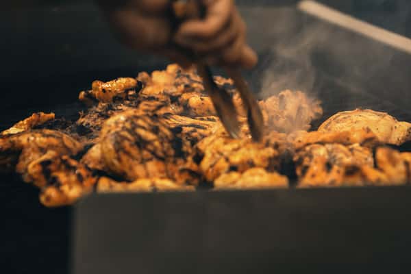person cooking chicken