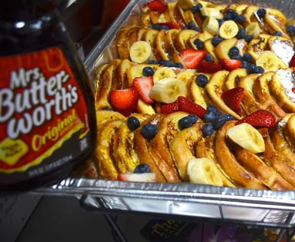 French toast in a tray with blueberries and strawberries