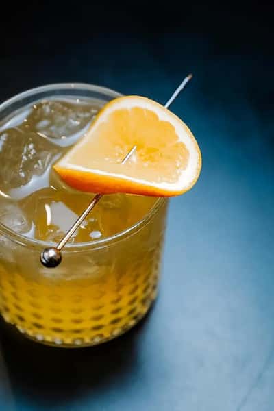 refreshing citrus cocktail with orange slice garnish in a chilled glass